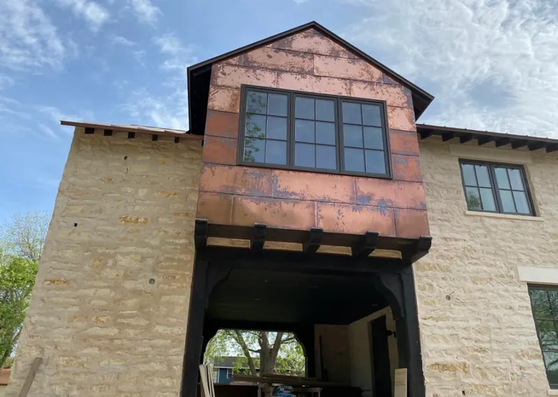 Copper metal panel facade on a stone building for Skylight Installation in Monfort Heights